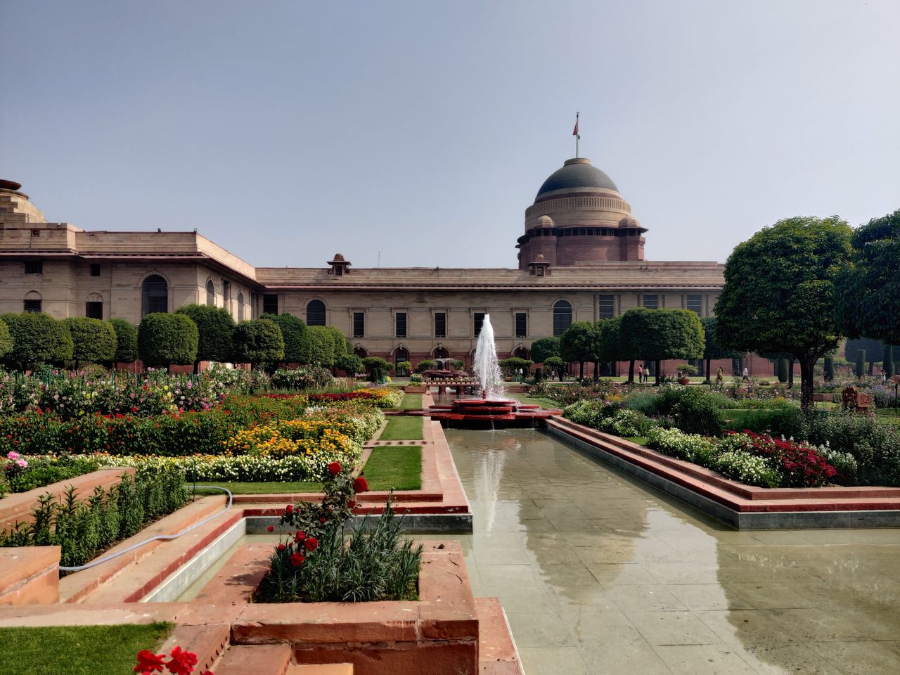 about-us Elegant Rashtrapati Bhavan gardens featuring a fountain and iconic dome in New Delhi, India.