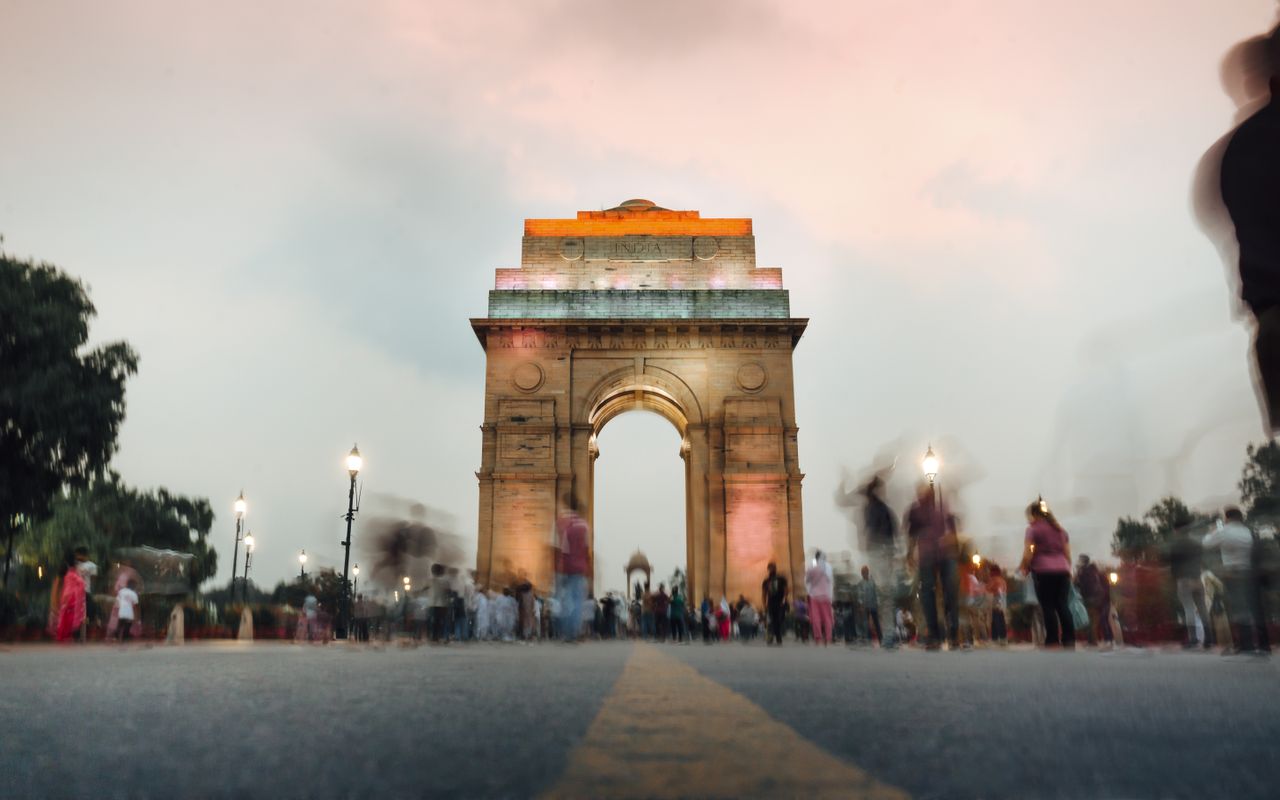 The Art of Drawing Readers In: Your attractive post title goes here A stunning view of India Gate in New Delhi at sunset with a dynamic crowd.
